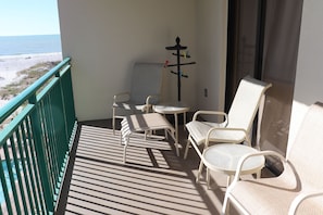 Balcony has 4 chairs, 1 ottoman, and towel holder
