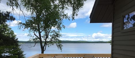 Lake view from deck. Plants & Tiki lanterns put on tables in summer.