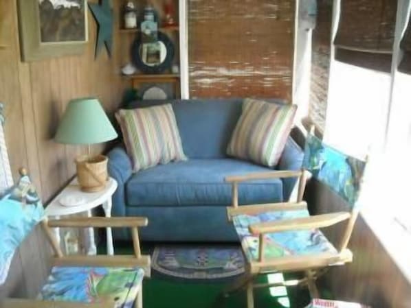 Enjoy the ocean breezes on the cozy porch. The over sized chair pulls out.