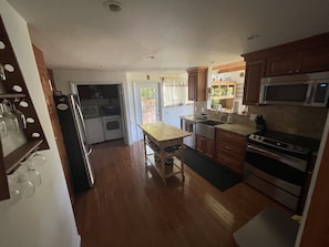Large kitchen with island, the large deck is just off the kitchen.