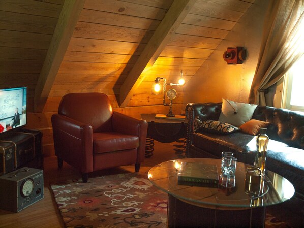 Classy, comfortable upstairs living room, with TV and wet bar. 