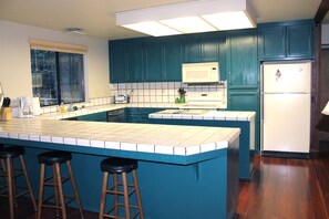 Large, open kitchen with counter seating.