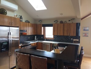 Kitchen sky light, all stainless steel appliances, marble backsplash