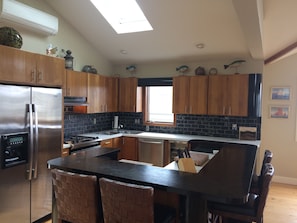 Kitchen sky light, all stainless steel appliances, marble backsplash