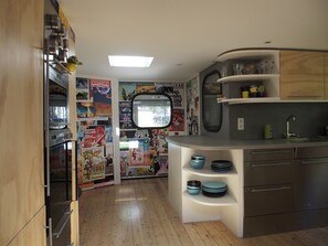 View from the kitchen of toilet, bedroom and bathroom doors (from left to right)