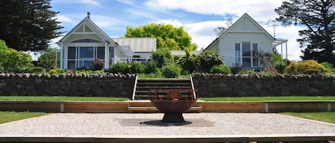 Looking at the house from the stone wall and fire pit
