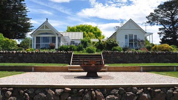 Looking at the house from the stone wall and fire pit
