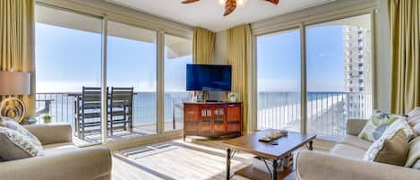 living room, wrap around balcony, 2 patio doors and picturesque view of gulf