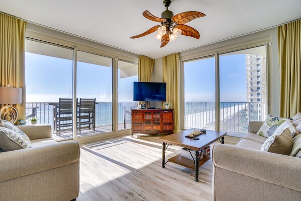 living room, wrap around balcony, 2 patio doors and picturesque view of gulf