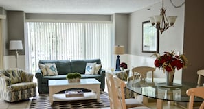 Living room/dining room with seating for six at the table.
