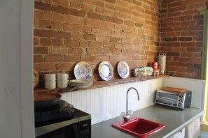 kitchen space, restored 1870's brick & hand planed 300 year old white oak shelf