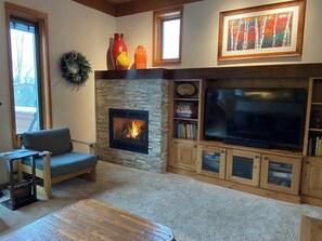 Cozy gas fireplace helps warm the living room.