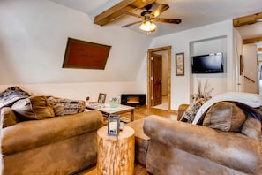 The living area has comfortable leather seating and a large flat screen TV with satellite programming.