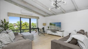 Step into our elegant living room with a big TV, perfect for gathering with your love ones.