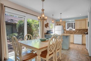 Dining table seats six plus two at breakfast bar