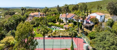 Aerial daytime view of private tennis and pickle-ball court