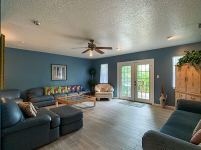 The large living room has french doors that open out to the deck. 2 sofas, TV