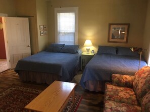 Two queen size beds, a love seat, dining area, full bath and kitchenette.