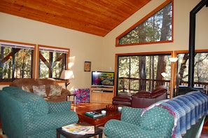 View of the openness of cabin with large open windows and sliding glass doors