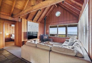 Open lounge area with wood burner, smart TV and DVD player