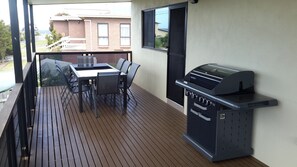 BBQ and outdoor dinning table.