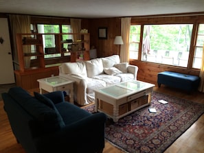 Living room area with picture window of the deck and lake