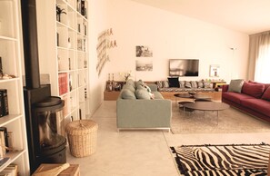 Living room with wood stove and tv
