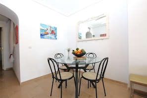 Modern dining area for four guests on a side of the lounge