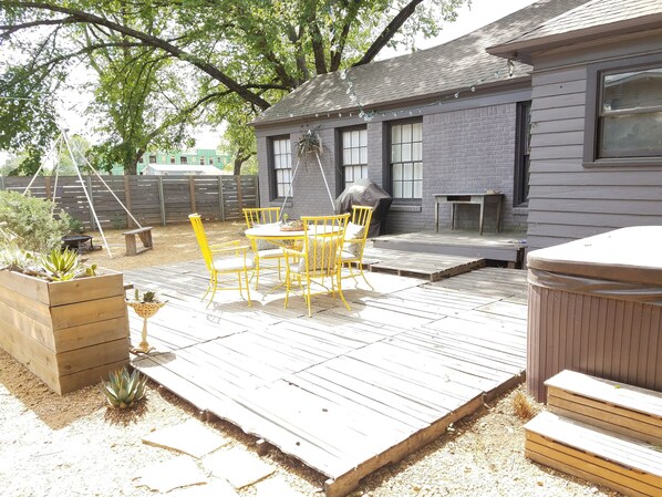 Large Backyard with Pallet Deck, Hot Tub, and a Vintage Air Stream.