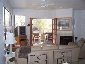 Living room opens up to screened in porch.  TV is upgraded to smart flatscreen!