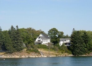 The Carriage House to the left, nestled in the pine trees. 