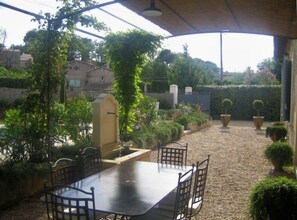 Enjoy a meal by the fountain in front of the pool