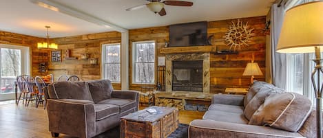 Living room with beautiful wood burning fireplace which is open to the kitchen