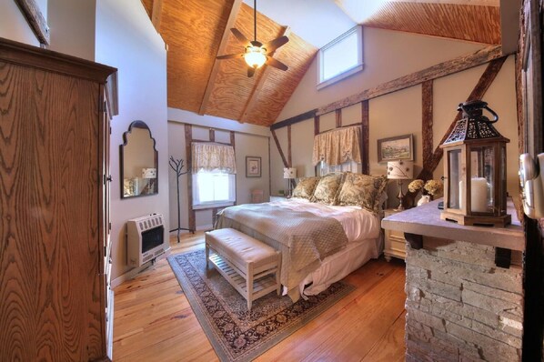Master bedroom, king bed, flat screen TV, and fireplace. 