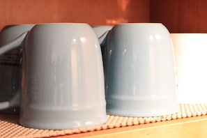 Eggshell blue stoneware coffee mugs are among dishes avaiallble.