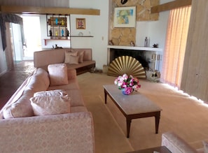 Main living room with sliding glass door to the pool patio.