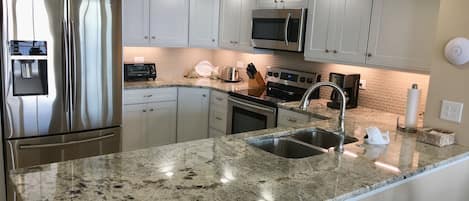 The custom kitchen is has a raised tray ceiling and crown molding.