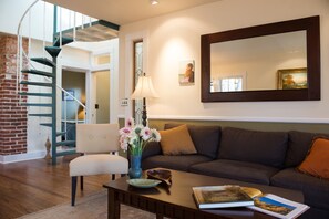 Living Room view to Spiral Staircase, leads to Loft with Queen Bed and the TV