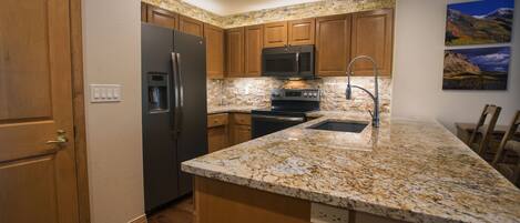 Fully equipped kitchen with barstools