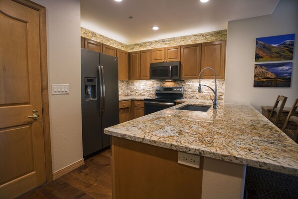 Fully equipped kitchen with barstools