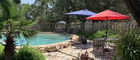 Tropical  swimming pool . Possibly shared with two other rentals on property.