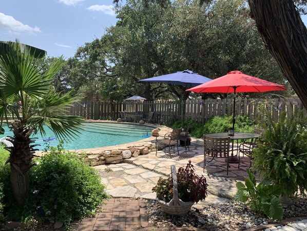 Tropical  swimming pool . Possibly shared with two other rentals on property.