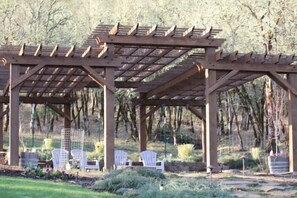 pergola with large paver patio and firepit