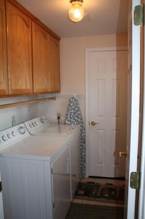 separate laundry room with washer/dryer and additional storage