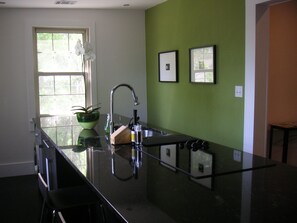 Kitchen island has countertop seating and integrated appliances