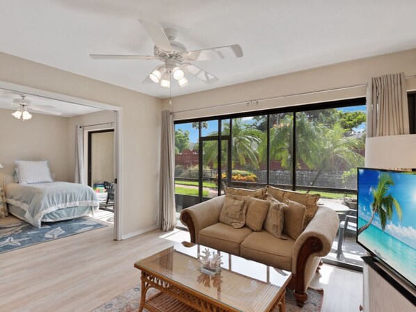 Open living area with glass sliders to lanai