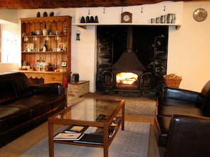 Two comfortable sofas and a log stove for chilly evenings off-season.