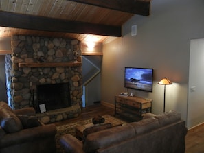 cozy lodge-style living room with stone fireplace
