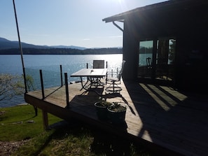 Patio table, six chairs and BBQ, door into kitchen.
