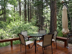 Start your day with a cup of coffee on this deck above a lovely creek.